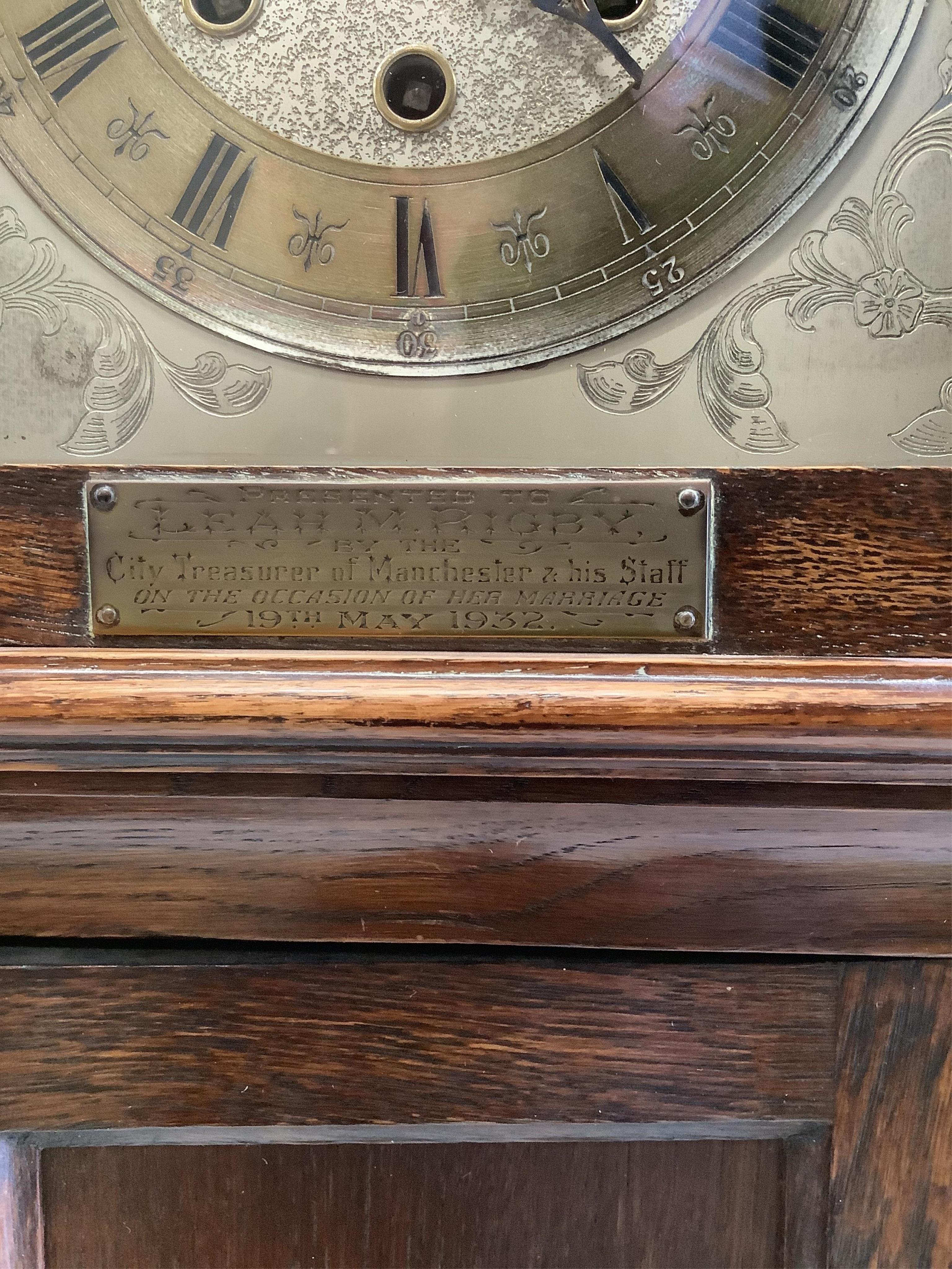 An early 20th century oak chiming grandmother clock with 1932 presentation plaque, height 167cm. Condition - fair to good, movement not tested